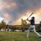 Little League team practices against sunset
